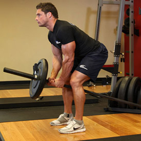 man moving into the starting position of a Two-Arm Long Bar Row https://get-strong.fit/Fitness