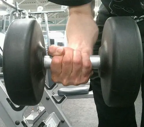 showing how to hold a dumbbell in palms up position https://get-strong.fit/Standing-Preacher-Curl/Exercises